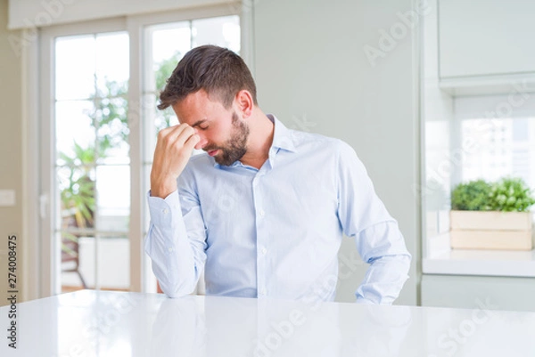 Fototapeta Handsome business man tired rubbing nose and eyes feeling fatigue and headache. Stress and frustration concept.