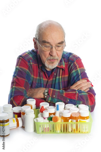 Obraz elderly man looking at his meds