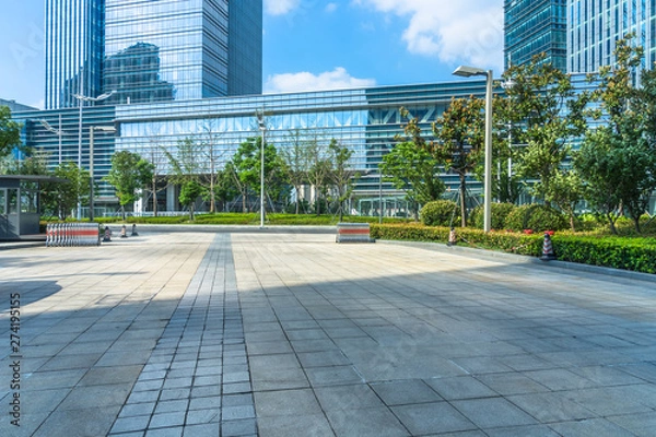 Fototapeta empty brick floor front of modern buildings.