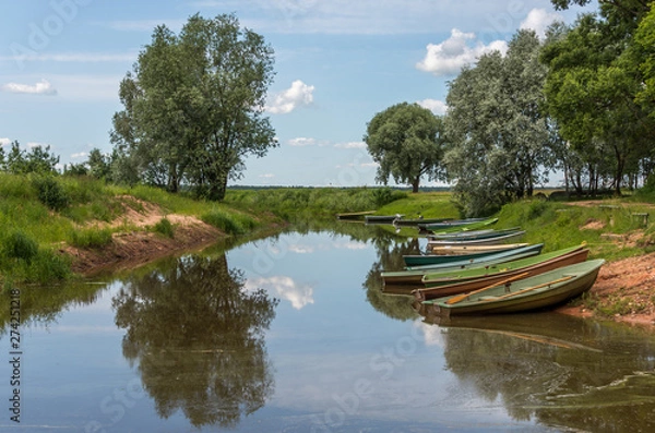 Obraz Small Fishing Boats on a Canal at a Lake in Latvia