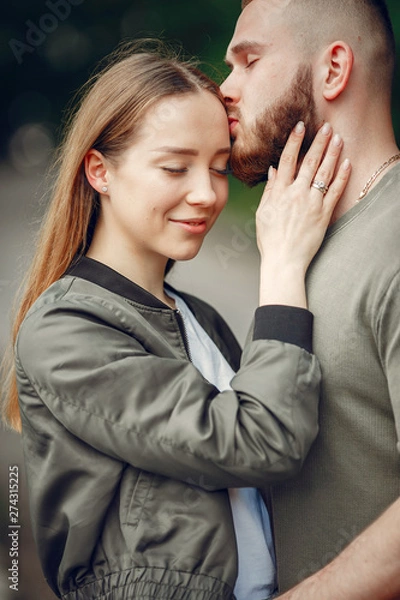 Fototapeta Couple in a forest. Man in a green t-shirt
