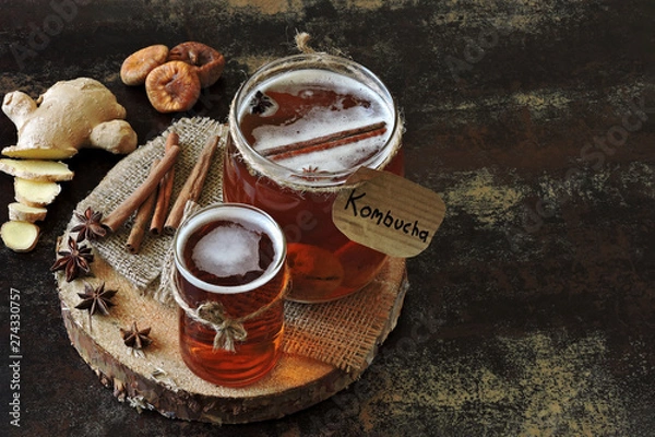 Fototapeta Homemade kombucha with ginger and cinnamon. Recipe cooking kombucha. Fermented beverages. Copy space.