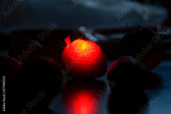 Obraz Strawberry flamy in black background