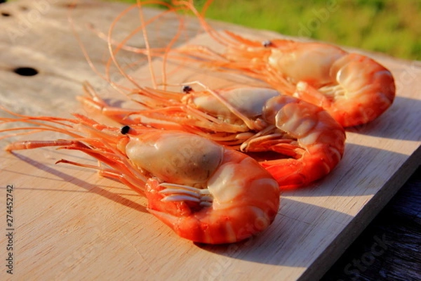 Obraz Shrimp is cooked  placed on a brown wood floor. 