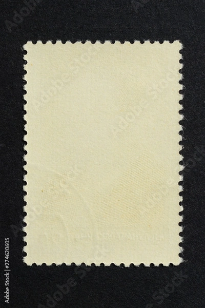 Fototapeta Blank vintage vertical postage stamp on black background. Mockup with perforations for your picture text or design 2.