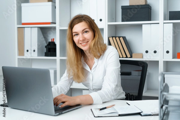 Obraz pretty blond young woman serfing the internet use laptop sit at table in office
