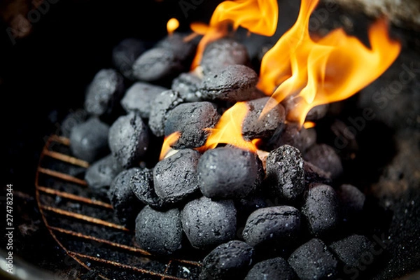 Obraz Closeup of glowing coal in metal grill on summer day in garden