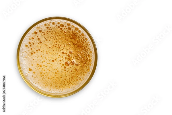 Fototapeta top view of beer bubbles in glass cup on white background. empty space for design. with clipping path.
