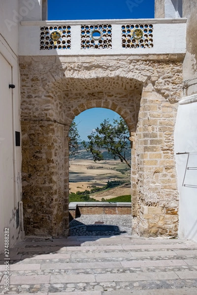 Fototapeta Countryside landscape viewed from the medieval gate of Montescaglioso old town. Basilicata, Italy