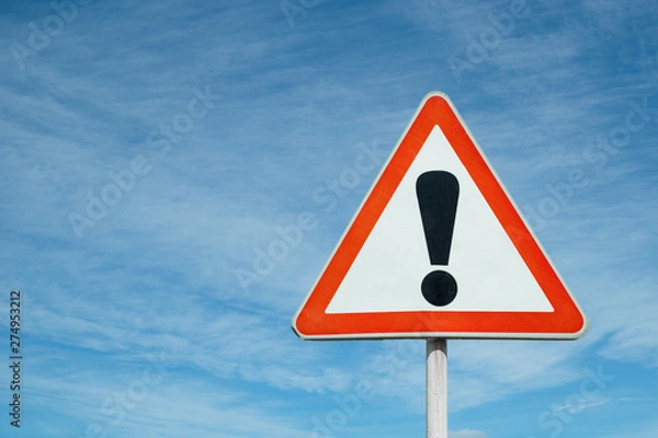 Fototapeta Exclamation point of attention against the sky. triangular sign. Danger, warning.