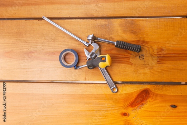 Obraz A various assortment of tools is laying on a wooden surface