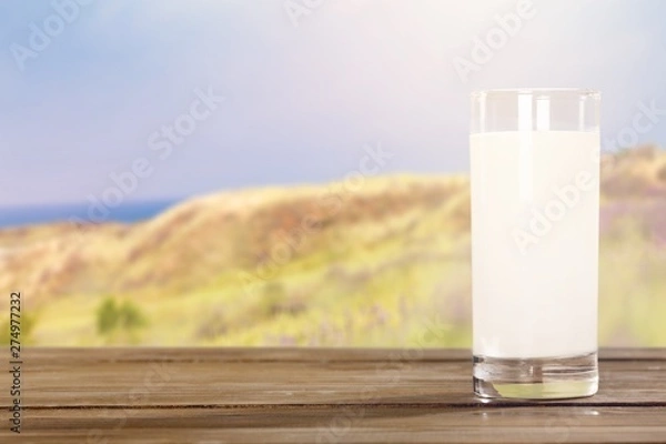 Fototapeta Glass of milk  for breakfast on  background