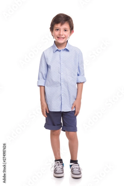 Fototapeta Boy standing smiling on a white background