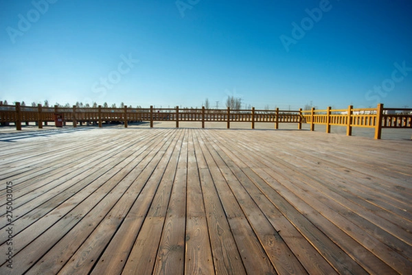 Fototapeta A close-up of the boardwalk on the waterfront