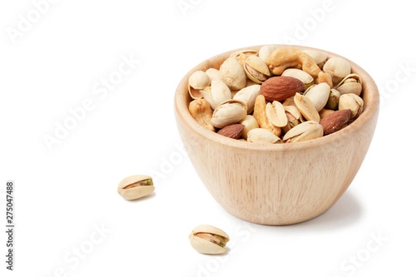 Fototapeta mixed nuts in white wooden bowl isolated on white background.