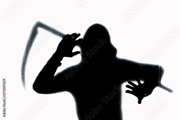 Fototapeta Dangerous man behind frosted glass with a scythe in his hand. Halloween. Black and white image.