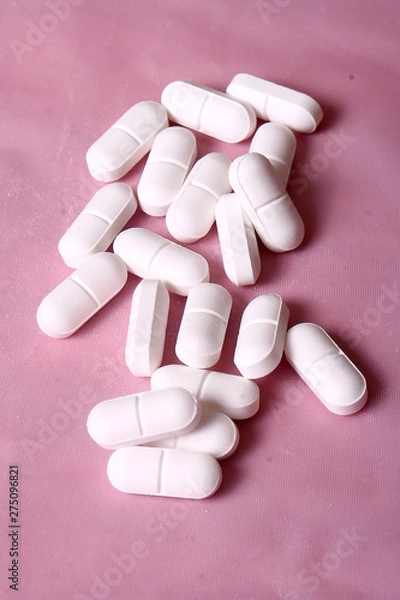Fototapeta White pills on the table