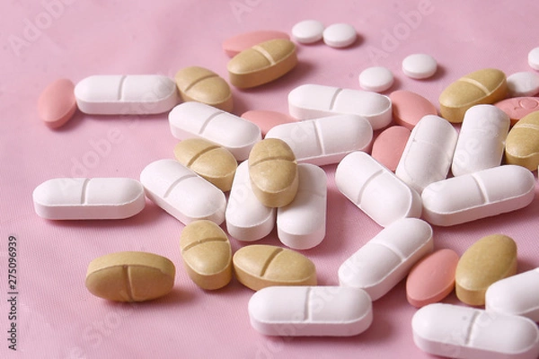 Fototapeta Different pills on pink background