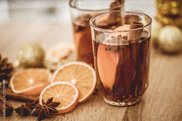 Fototapeta Mulled wine in night celebration of  New Year party and a delicious Christmas drink for autumn and winter season
