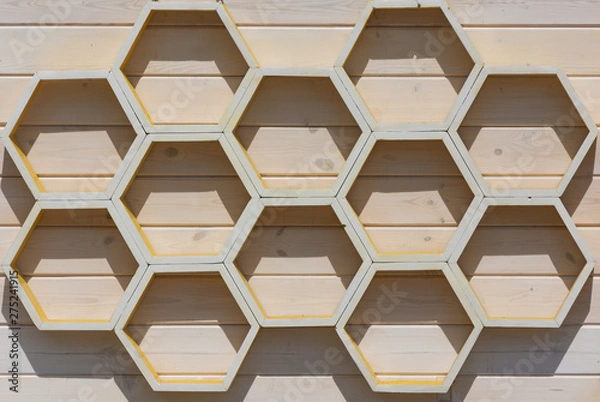 Obraz A honeycomb pattern made of wooden planks illuminated by bright outdoor light.
