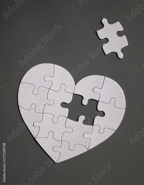 Fototapeta White heart shaped puzzle with missing part.