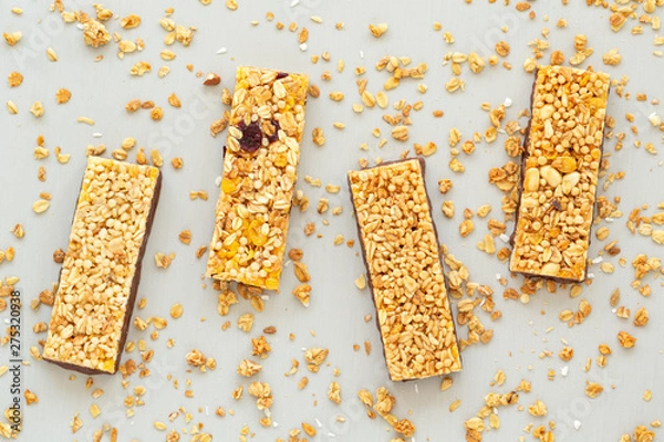 Fototapeta Cereal granola bar with nuts, fruit and berries. Granola bar. Healthy sweet dessert snack. Dietary food. Top view. 