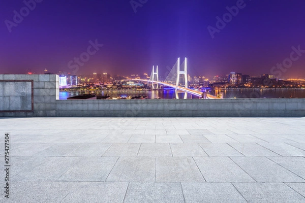 Fototapeta Empty square floor and bridge buildings at night in Shanghai,China