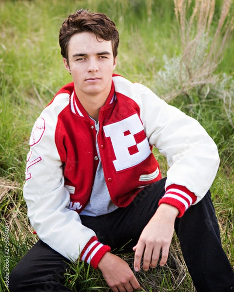 Obraz High school senior male posing in his letter jacket. 