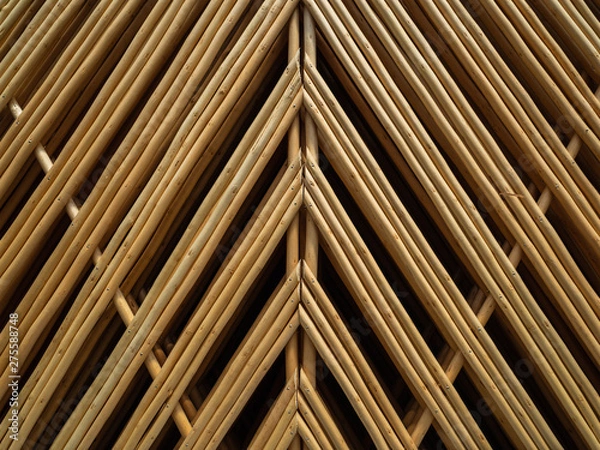 Fototapeta A fence made of thin branches. Related tree branches. A lot of wooden rods