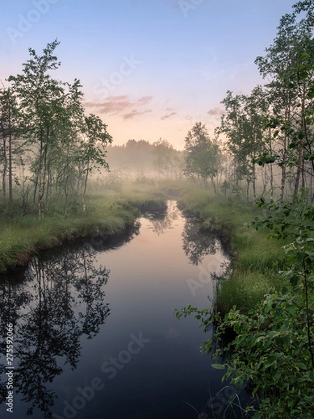 Fototapeta Idyllic river view with tranquil and foggy sunset at summer night in wetland, Finland