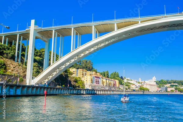 Fototapeta Arrabida Bridge in Porto Portugal, crossing the Douro River and linking Porto with Vila Nova de Gaia