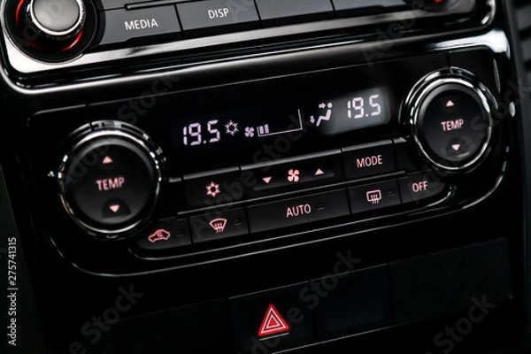 Fototapeta Black detail with the air conditioning button, the dashboard with information about temperature inside a car. modern car interior: parts, buttons, knobs..