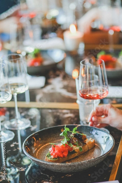Fototapeta Close-up of food and wine glass on dining table in restaurant