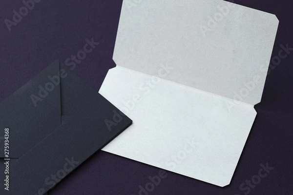 Fototapeta White blank business card and black envelopes on dark background. 3d rendering.