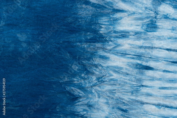 Fototapeta Pattern of blue tie batik dye on cotton cloth, Dyed indigo fabric background and textured