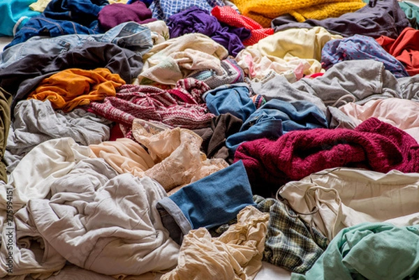 Fototapeta pile of used clothes on a light background. Second hand for recycling