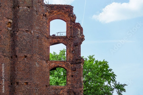 Fototapeta Ruins from an old brick building against the sky. Empty windows
