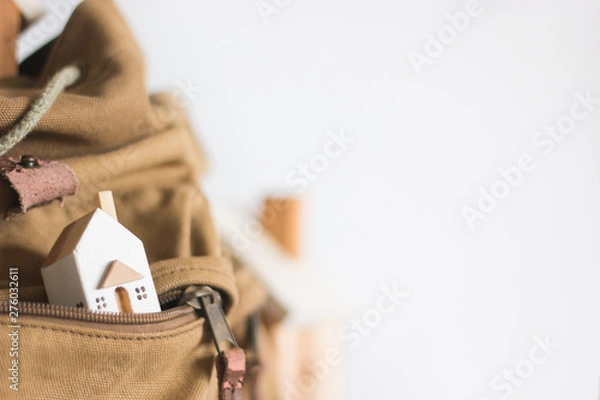Fototapeta Miniature house model in the brown color Zipper pocket on white background, Property investment concept, copy space, isolated