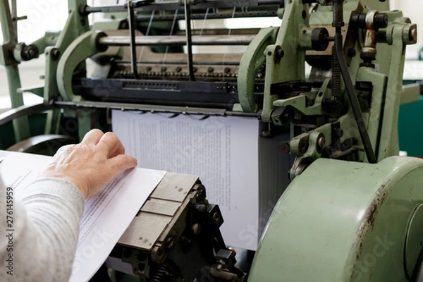 Obraz Machine for stitching book pages with threads in typography.