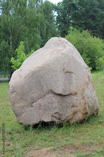 Fototapeta  A huge stone in the middle of a green glade