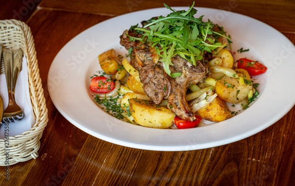 Fototapeta Roasted sheep meat with potatoes and beans