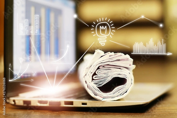 Obraz News. Computer and newspapers with virtual graphs and charts as concept for business news. Data analysis and planning                         