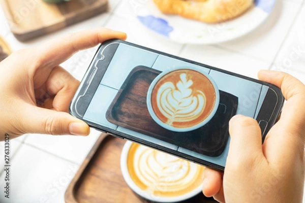Fototapeta take photo latte coffee with mobile phone