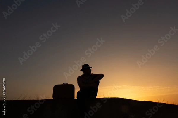 Obraz silhouette of man with suitcase at sunrise