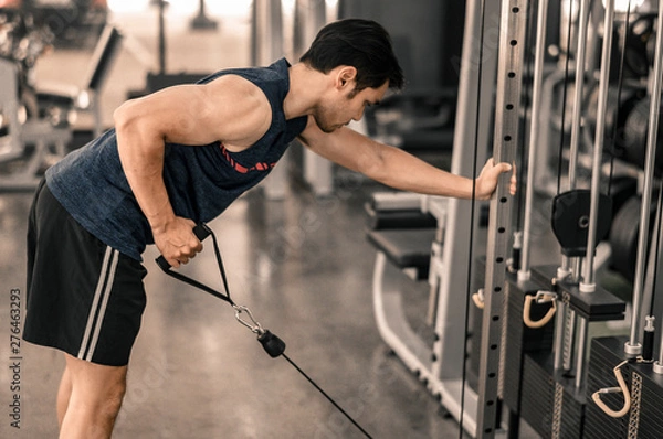 Fototapeta Man workout at the gym