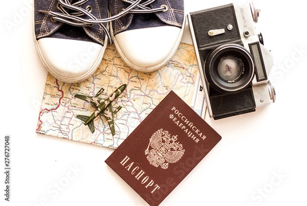 Fototapeta Young traveler planning a vacation. Travel accessories, passports, baggage, map, prepared for the trip. Suitcase travel preparation concept