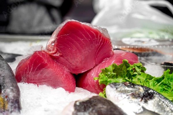 Obraz Fresh raw tuna slice with lemon on fishmonger