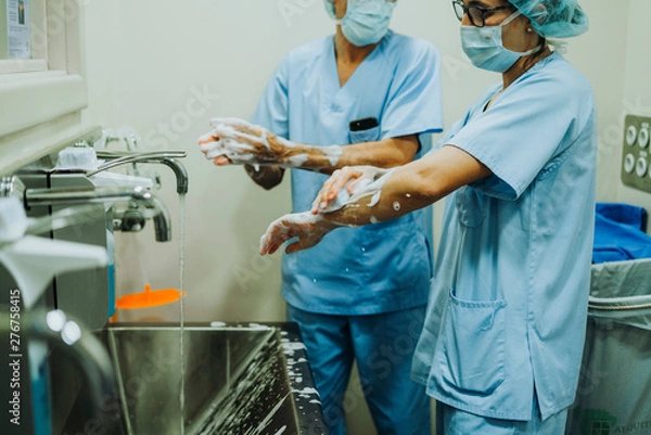Fototapeta Unrecognizable doctor washing hands before operating