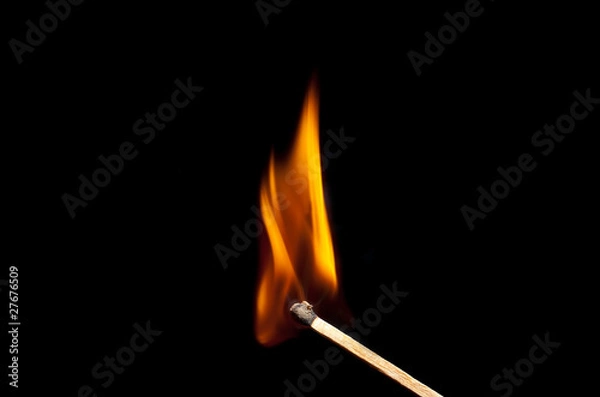Fototapeta burning match on black background