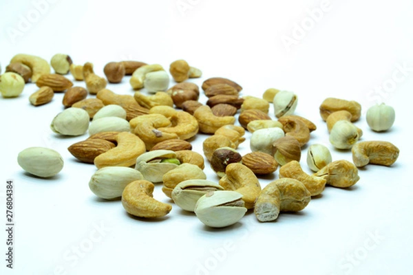 Obraz nuts almonds cashew hazelnuts scattered on white background